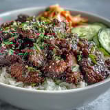 Hot Korean Beef Bowl with spicy gochujang glaze and fluffy white rice.