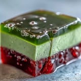 Golden brown yokan topped with vibrant green matcha, ready to chill.