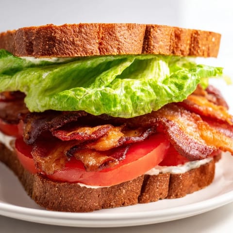 Fresh ingredients overflowing the BLT sandwich are ready to satisfy your hunger cravings.