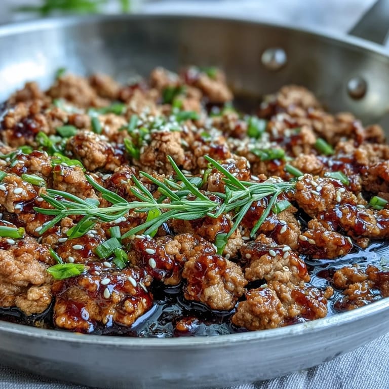 Savory Korean-Style Ground Turkey topped with green onions and sesame seeds, served alongside fluffy white rice and crisp steamed broccoli.