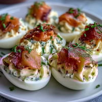 Smoked salmon deviled eggs topped with everything bagel seasoning for a savory, brunch-worthy appetizer.