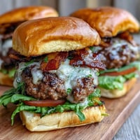 Juicy Father's Day grilled bacon burger sliders with melted cheese and crisp toppings.